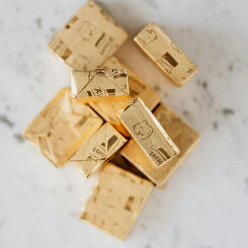 Broth cubes in golden wrappers on table