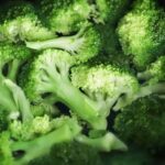 Bright green broccoli florets boiling in a pot for a fresh, healthy meal.