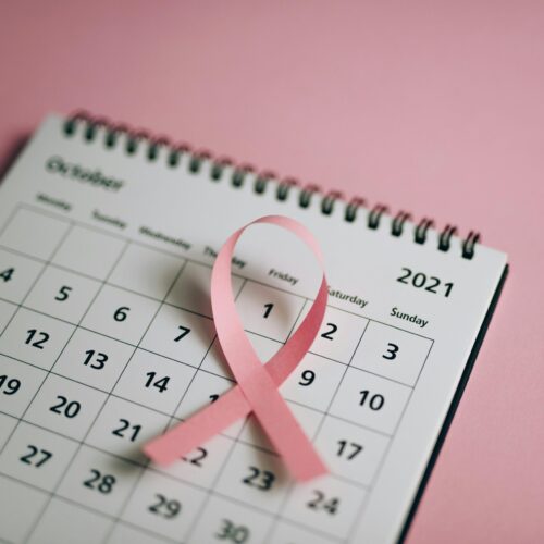 Pink ribbon on an October calendar for breast cancer awareness.